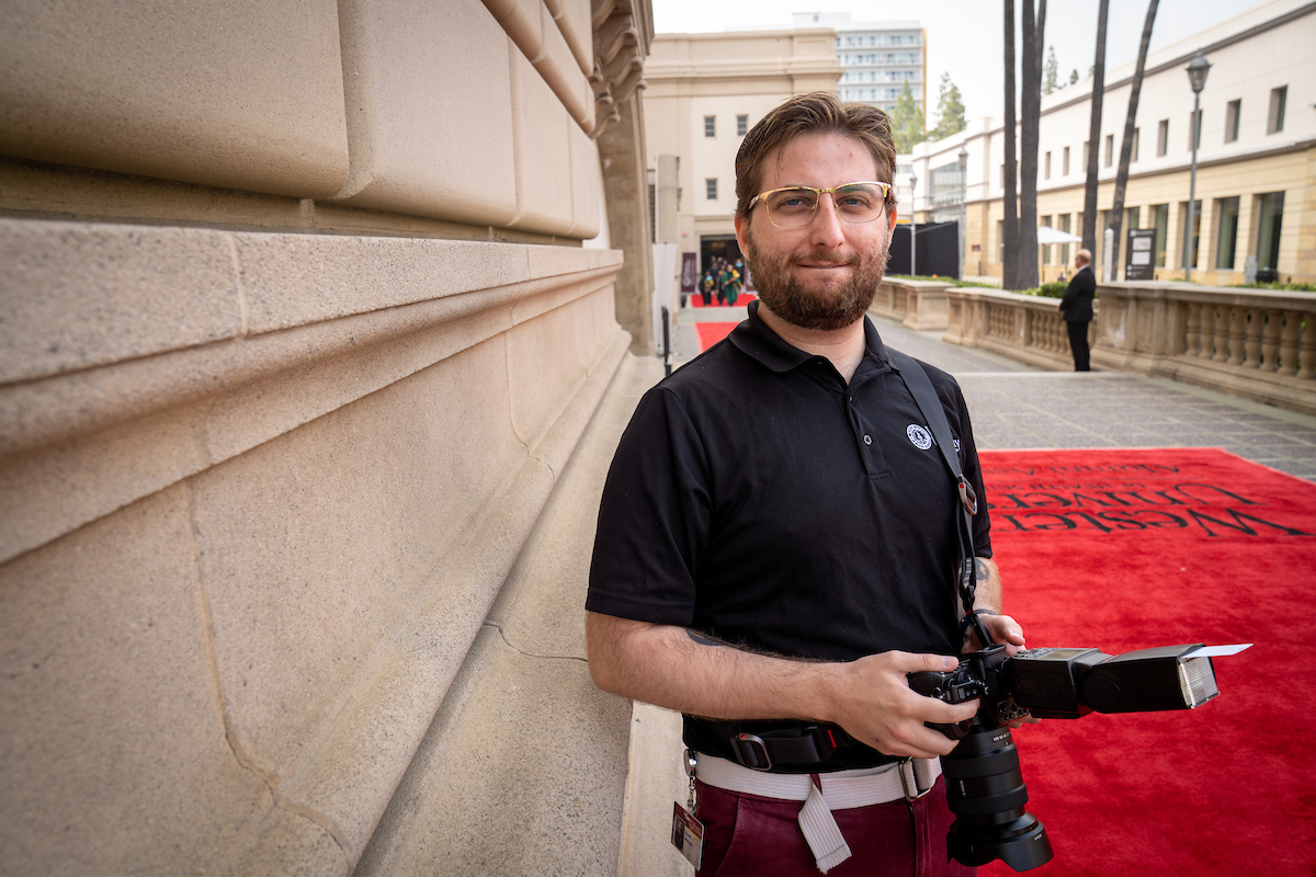 University photographer posing for a photo. University photographer posing for a photo.