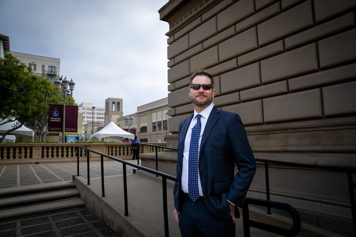 University security officer standing near a ramp outside of the PCA with a view of buildings in the background. University security officer standing near a ramp outside of the PCA with a view of buildings in the background.